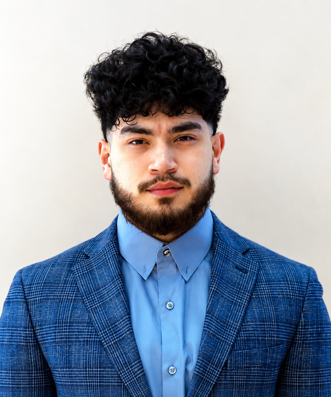 Portrait of Silvestre Perez, owner of Silvestre Construction LLC, wearing a blue suit jacket and shirt.